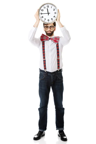 Man wearing suspenders holding big clock. — Stock Photo, Image