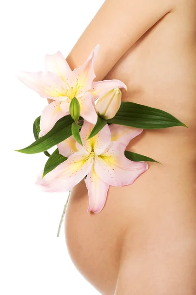 Pregnant woman holding a lily flower — Stock Photo, Image