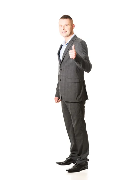 Businessman gesturing thumb up sign — Stock Photo, Image