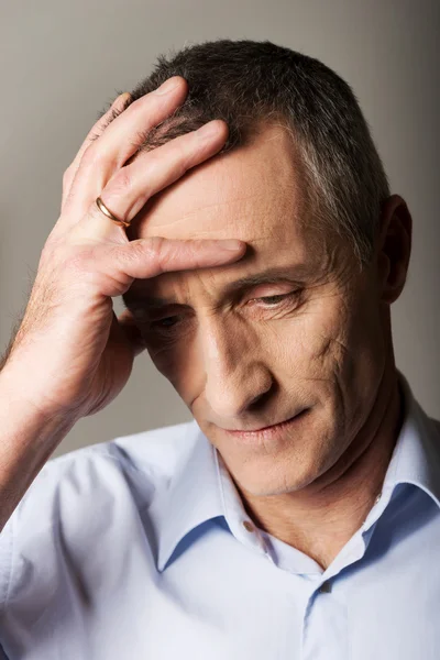 Mature man touching his head — Stock Photo, Image