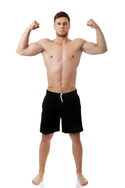 Young athletic man showing his muscles. — Stock Photo, Image