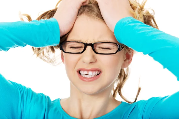 Frustrated teenage woman pulling her hair — Stock Photo, Image