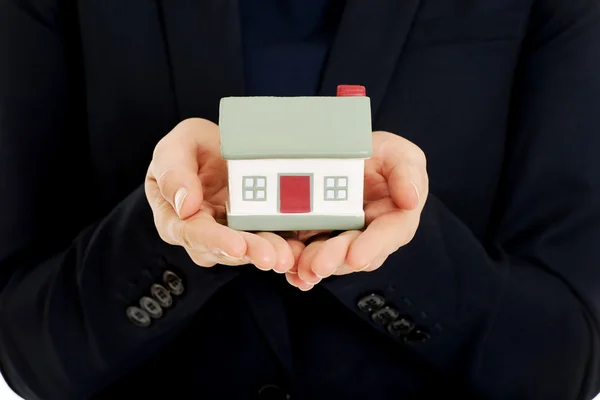 Agent holding house model. Royalty Free Stock Images