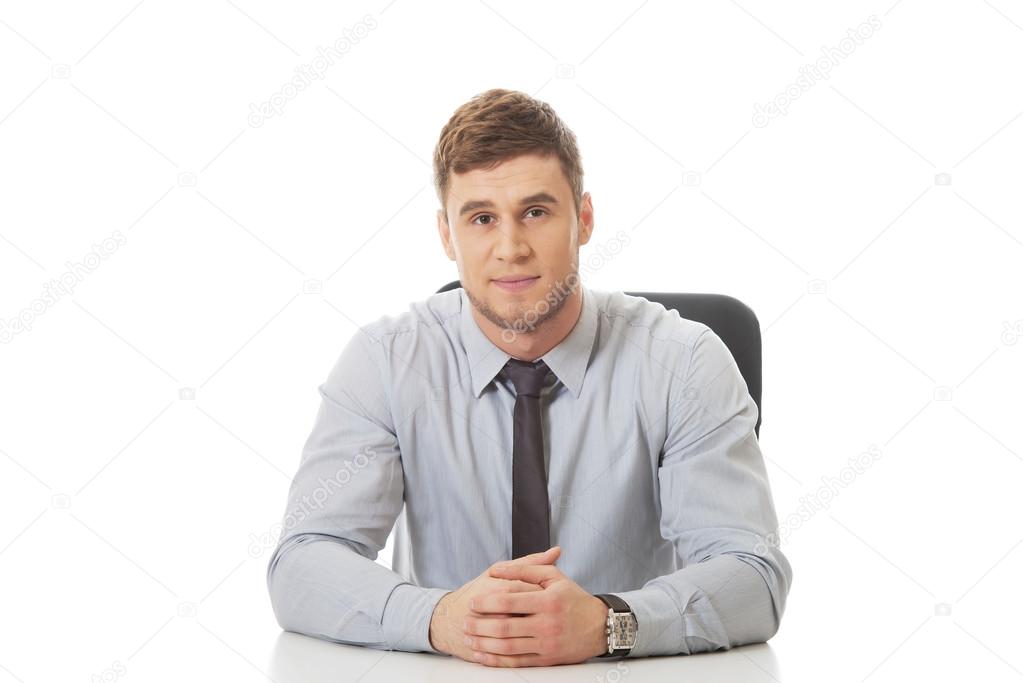 Businessman sitting by a desk in the office.