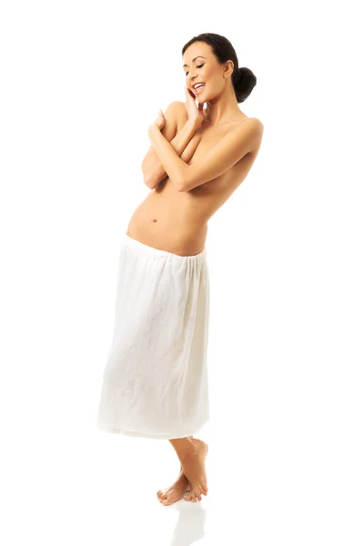 Woman standing wrapped in towel — Stock Photo, Image