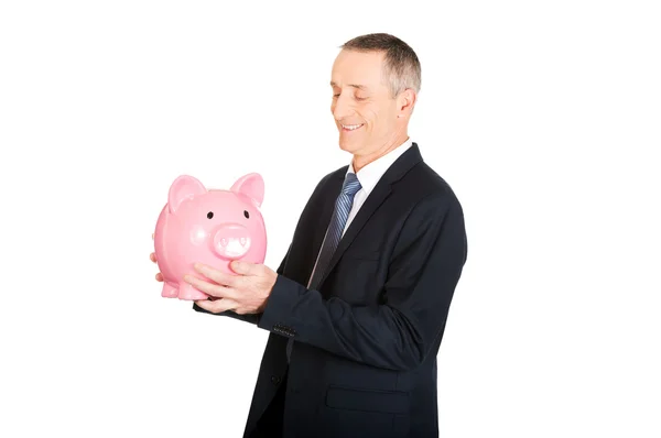 Affärsman med piggybank — Stockfoto