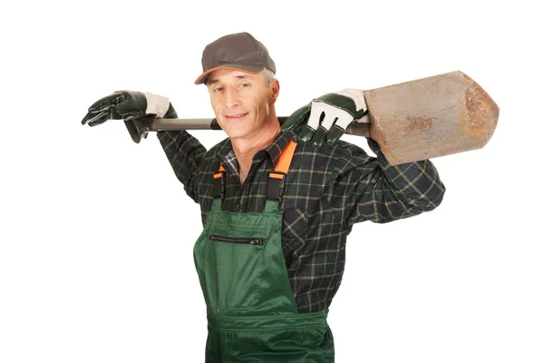 Mature gardener holding a spade — Stock Photo, Image