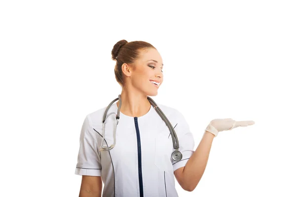 Female doctor presenting copyspace on hand — Stock Photo, Image