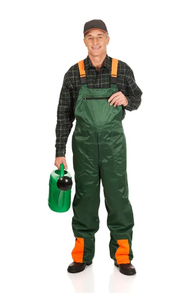 Workman holding green watering can — Stock Photo, Image