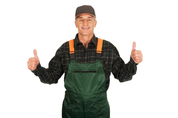 Mature gardener in uniform with thumbs up — Stock Photo, Image