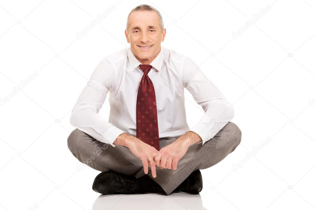 Businessman sitting cross-legged on the floor