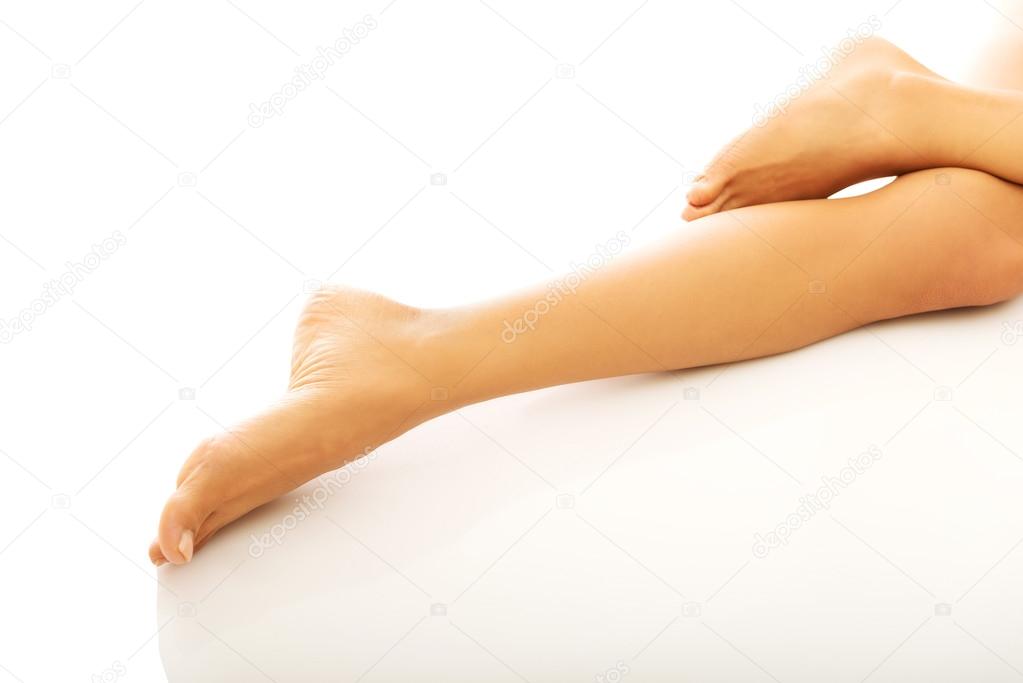 Womans naked crossed legs lying