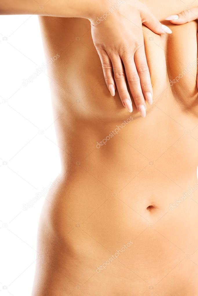 Beautiful topless woman examining her breast