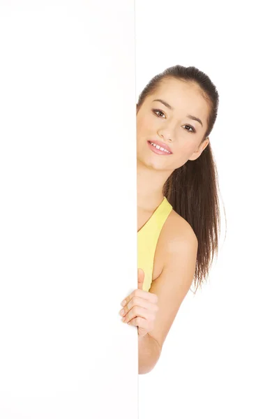 Fitness woman with empty placard. — Stock Photo, Image