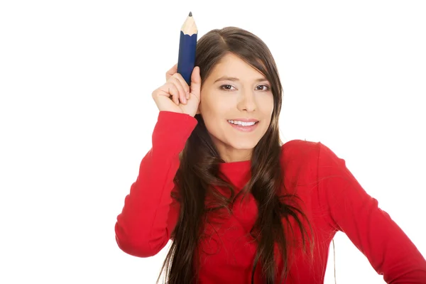 Beautiful student with a big pencil. — Stock Photo, Image