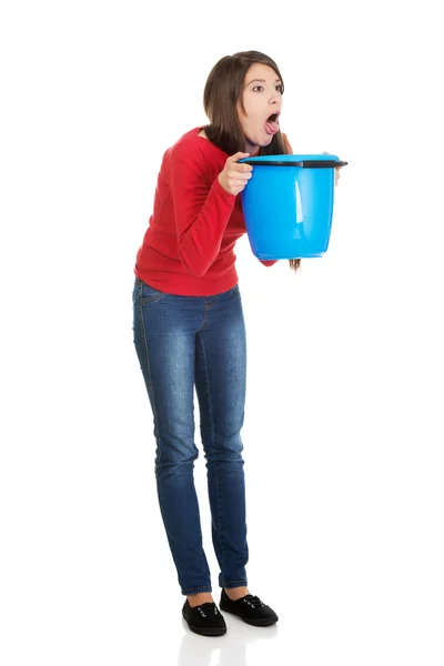 Woman vomiting to bucket. — Stock Photo, Image