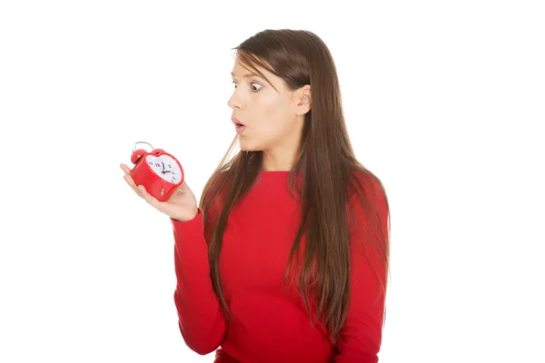 Shocked woman with alarm clock. — Stock Photo, Image