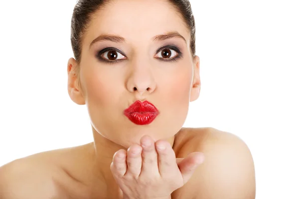 Woman with make up blowing a kiss. — Stock Photo, Image