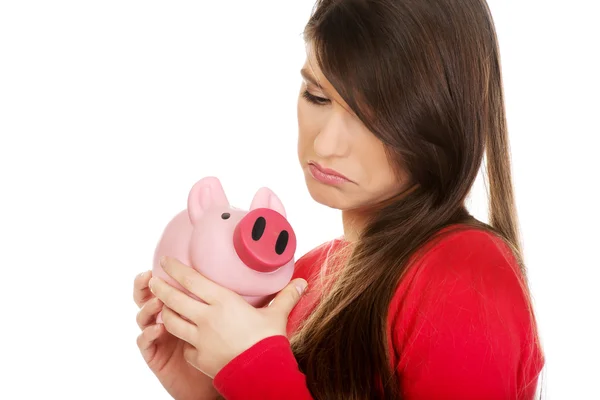Worried woman with piggybank. — Stock Photo, Image