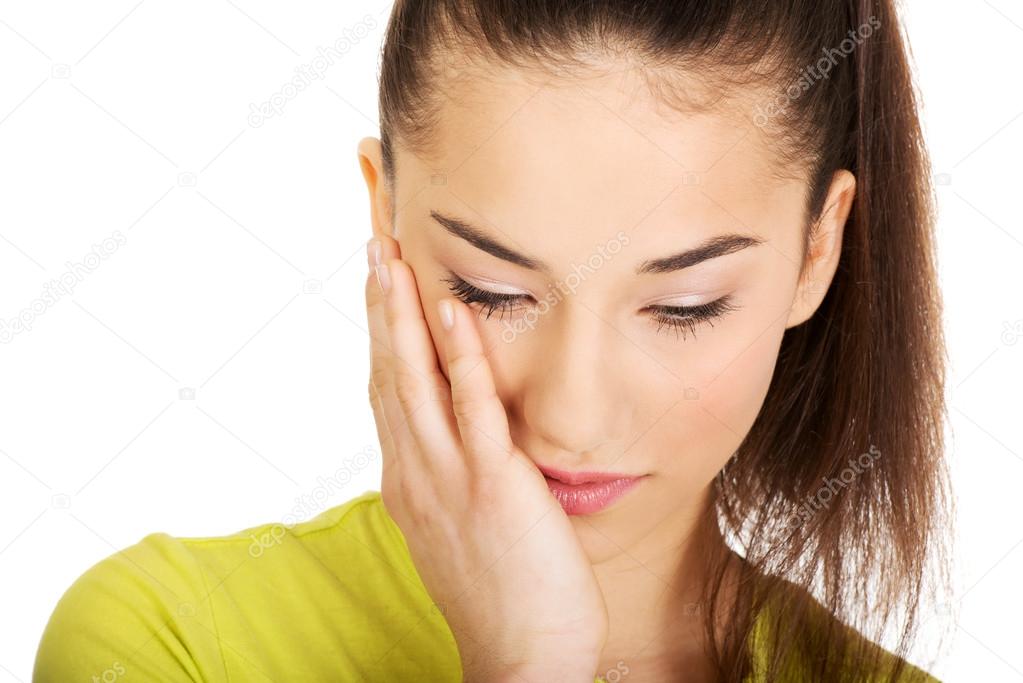Woman with a toothache touching face.