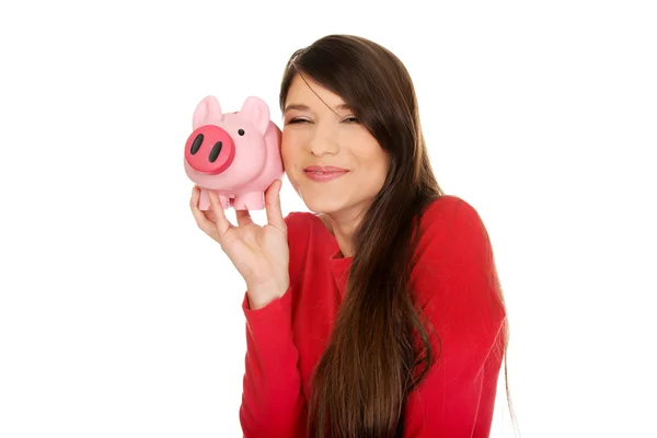 Glad ung kvinna med piggybank. — Stockfoto