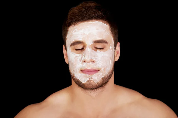 Man with cream moisturizer on his face. — Stock Photo, Image