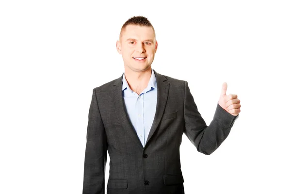 Usinessman gesturing thumb up sign — Stock Photo, Image