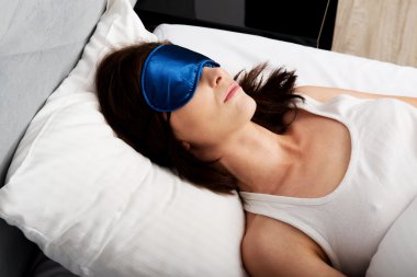 Göz bandı ile uyuyan kadın.