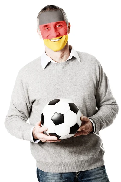 Зрелый мужчина с флагом Германии на лице . — стоковое фото