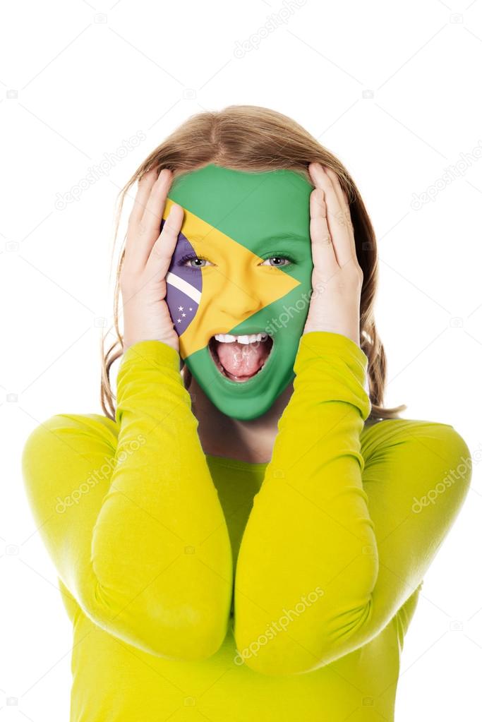 Brazilian flag painted on woman's face.