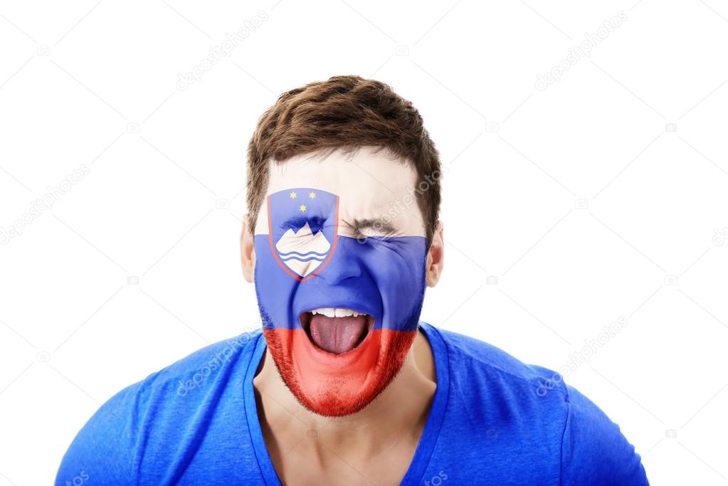 Screaming man with Slovenian flag on face.