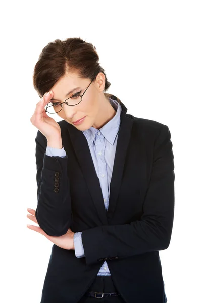 Worried businesswoman touching her head. — Stock Photo, Image