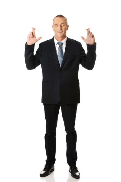 Businessman with fingers crossed — Stock Photo, Image