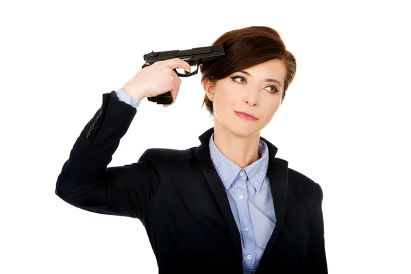 Woman in business suit holding a gun. Stock Image