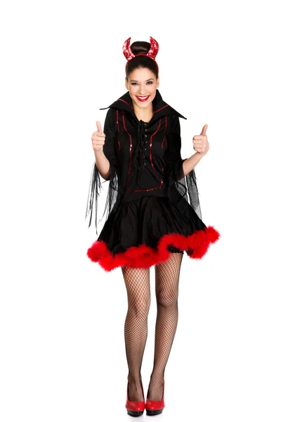 Vrouw in duivel kostuum met Duimschroef opwaarts. — Stockfoto