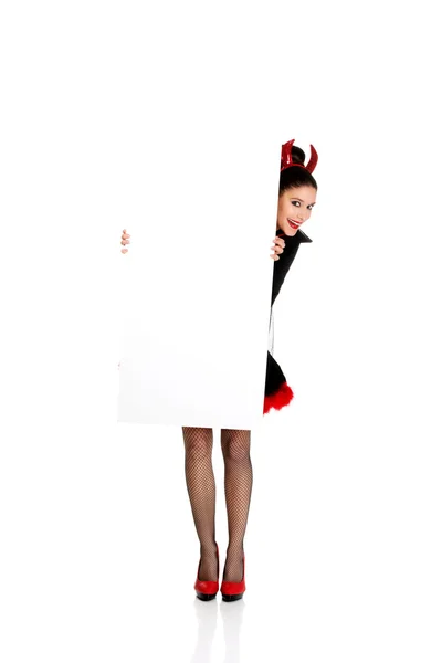 Donna in costume da diavolo con banner vuoto . — Foto Stock