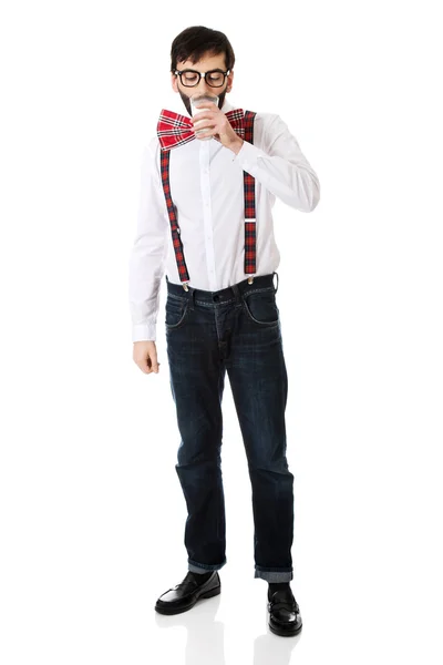 Man wearing suspenders drinking milk. — Stock Photo, Image