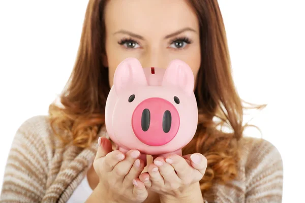 Casual woman holding piggy-bank. — Stock Photo, Image