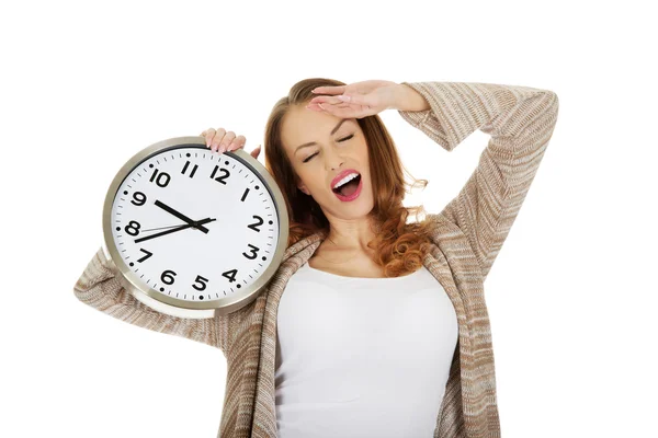 Tired woman with clock. — Stock Photo, Image