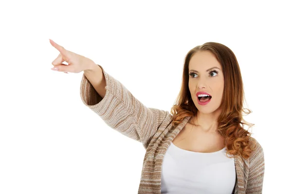 Shocked woman pointing away. — Stock Photo, Image