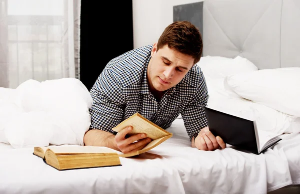 Thoughtful man with a book in his bed. — Stock Photo, Image