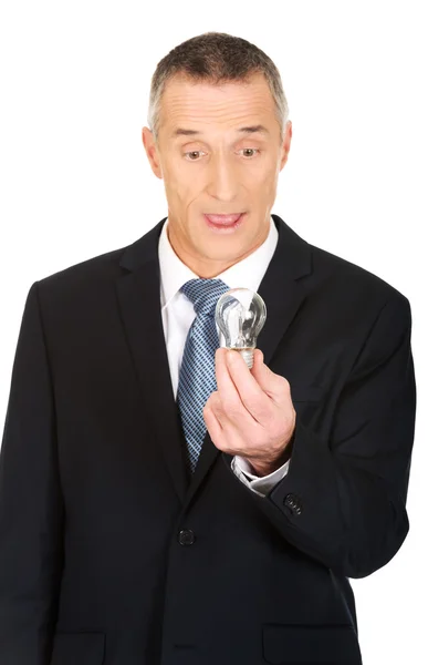 Shocked businessman with light bulb — Stock Photo, Image