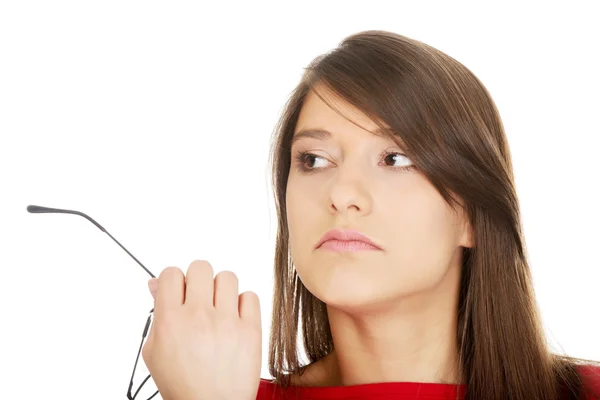 Thoughtful woman holding glasses. — Stock Photo, Image