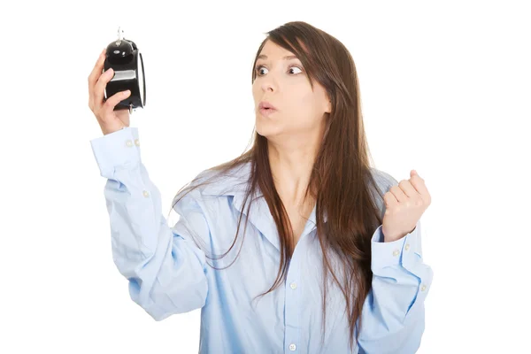 Shocked woman holding alarm clock. — Stock Photo, Image