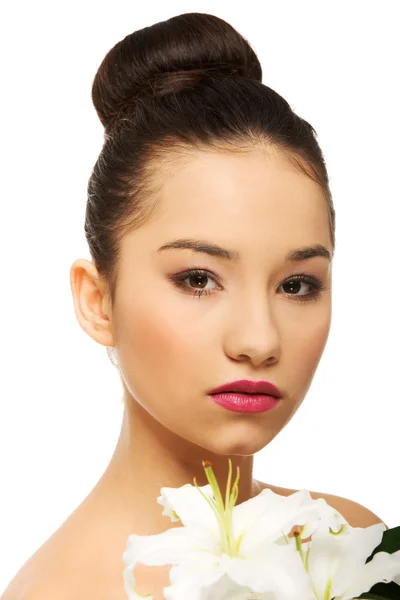 Beauty face of a woman with flower. — Stock Photo, Image