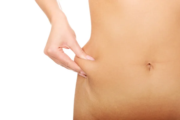 Slim woman pinch her belly. — Stock Photo, Image