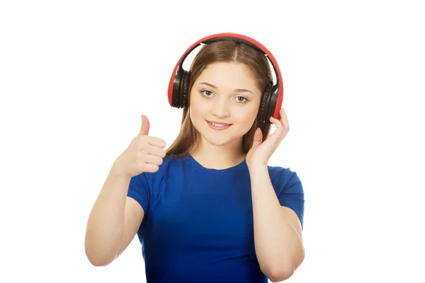 Woman with headphones and thumb up. Stock Photo