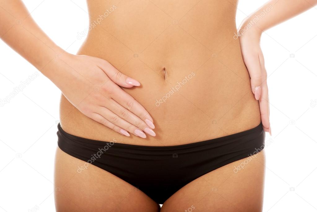 Woman touching her slim belly.