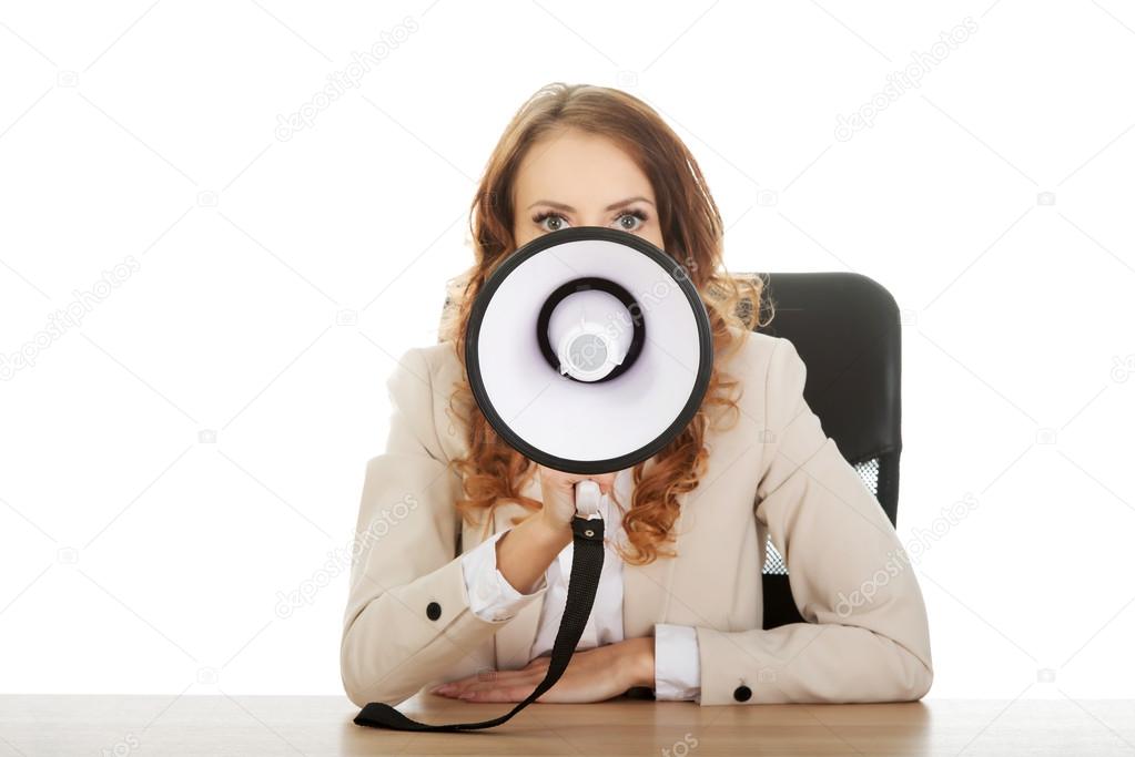 Businesswoman shouting through megaphone