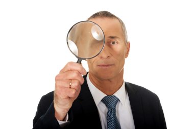 businessman with a magnifying glass clipart